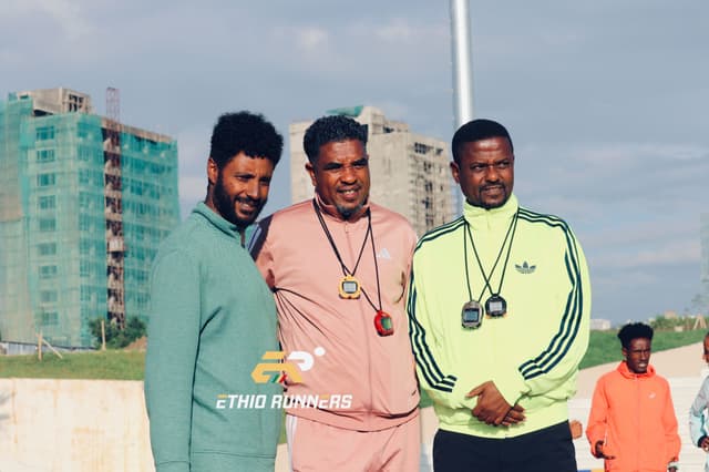 Coaches training athletes